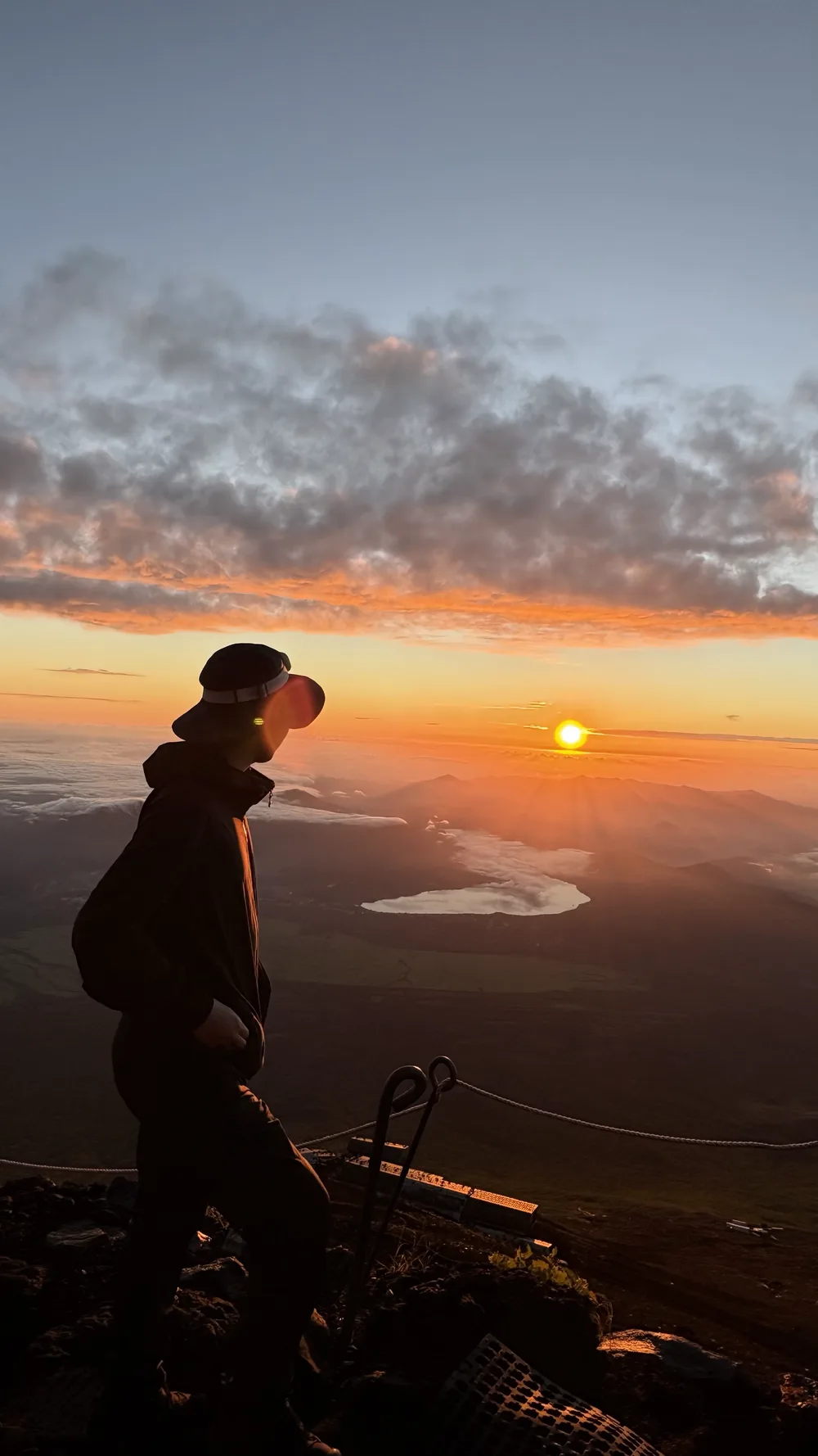 Satoshi Kameyama at sunrise on a mountain summit